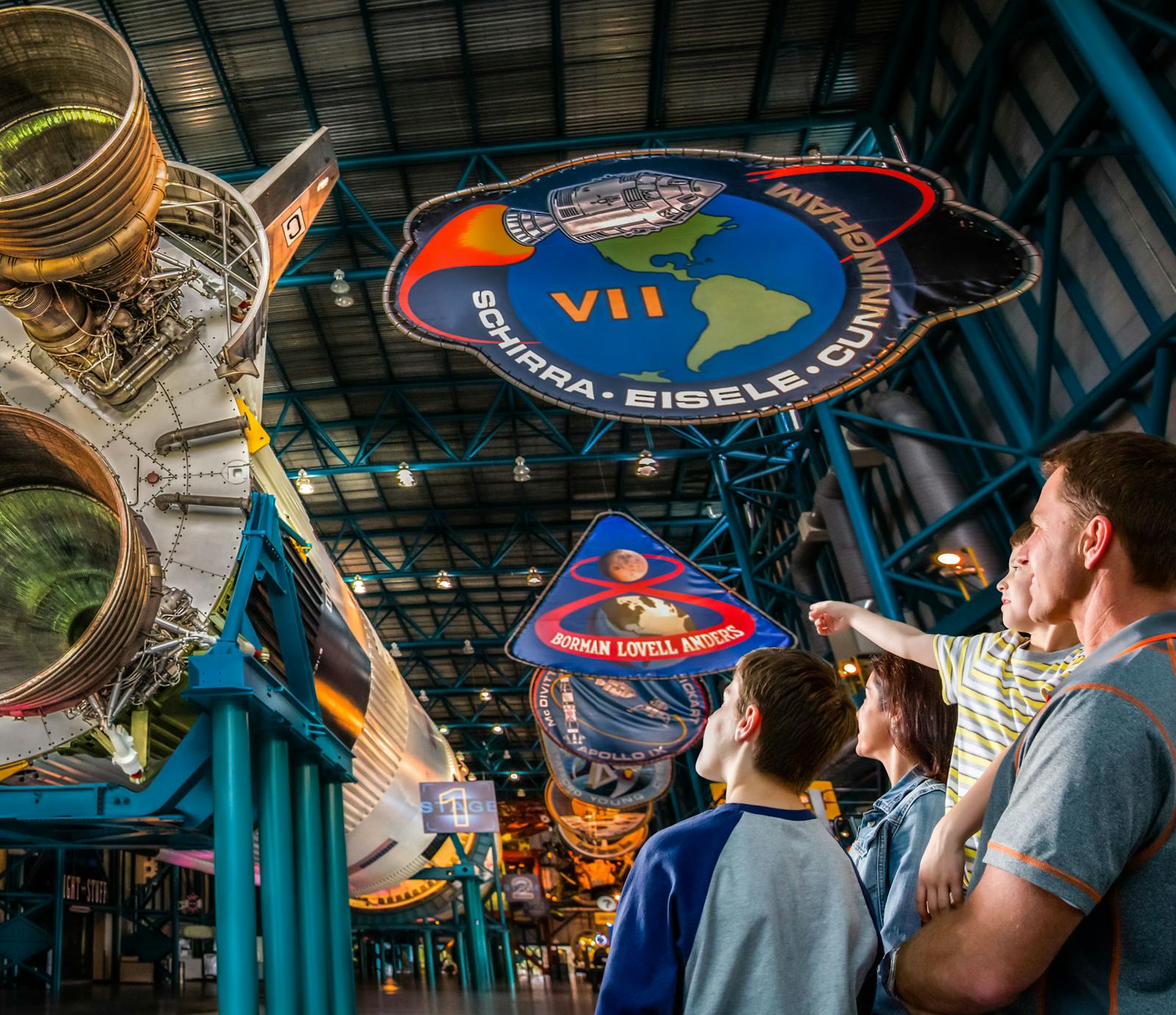 A family observing rockets at Kennedy Space Center